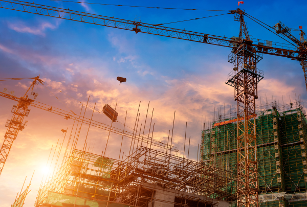Cranes against commercial construction
