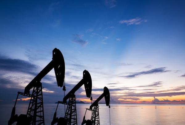 Oil pumps against sea horizon