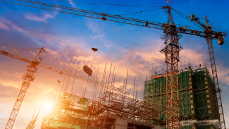 Cranes against commercial construction